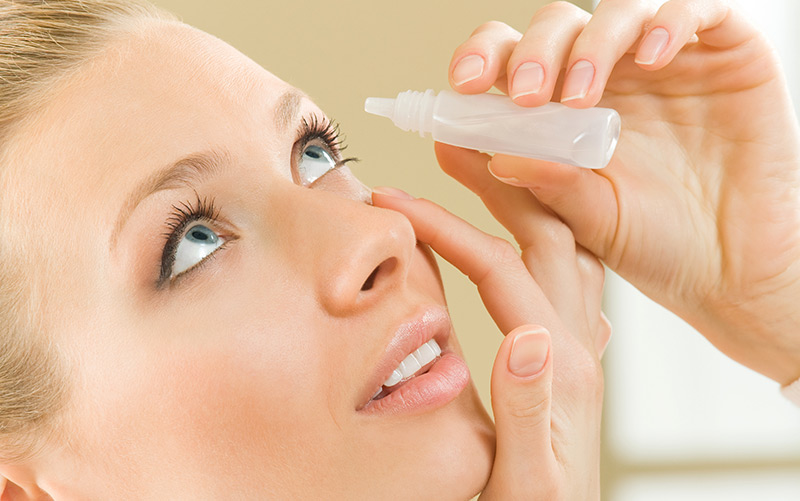 Woman using eye drops for dry eyes