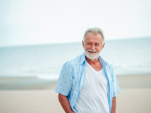 Older man smiling after macular degeneration treatment