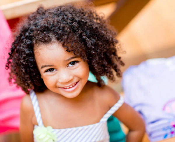 Child smiling after visiting an Eye Doctor