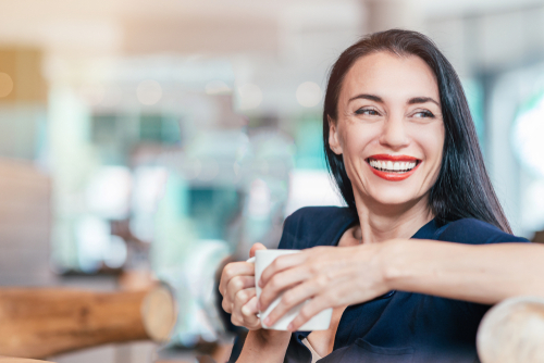 Woman smiling after visiting the eye doctor