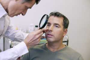 Doctor examining an eye before eyelid surgery