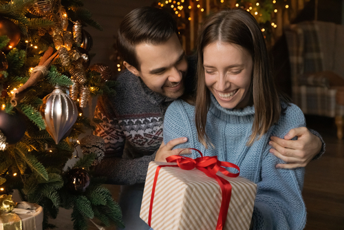 A woman receiving a Christmas gift