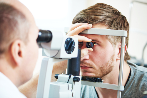 ophthalmologist performing eye exam on patient 