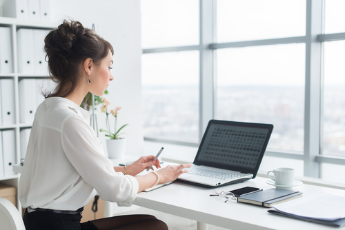 Businesswoman reviewing files on a laptop