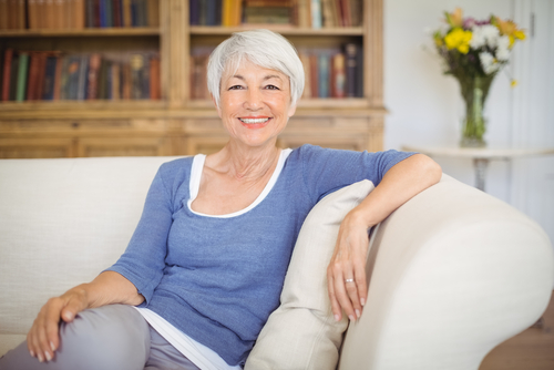 woman smiling while sitting on couch